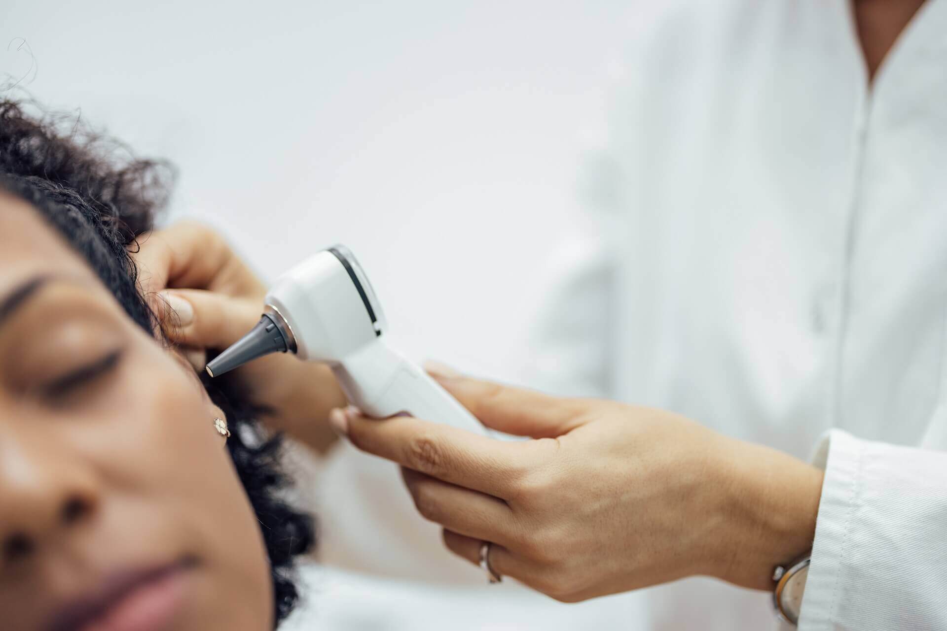 Doctor checking patient's ear